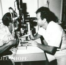 Dr Sheldon Kaplan, Opthalmologist, Rotation I, with patient.